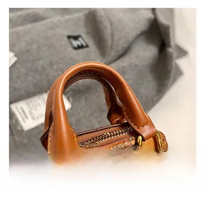 Détails du mini sac coquillage en cuir marron avec motifs de dessins animés et dorures