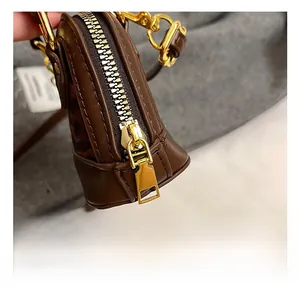 Close-up of golden zipper and premium hardware on leopard print mini crossbody bag