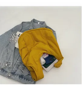 Spacious interior of yellow canvas backpack showing large capacity for daily items
