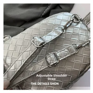 Detail view of silver woven leather texture with metallic buckle and adjustable strap