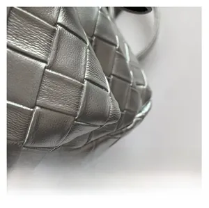 Detail shot of metallic silver leather weave highlighting the premium woven craft