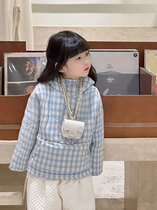 Detail view of quilted white mini chain bag and blue checkered hooded jacket for kids