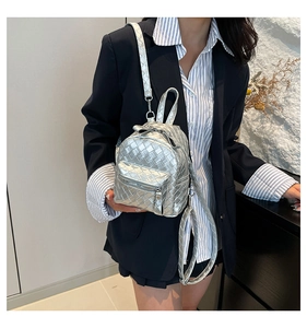 Detail of silver woven texture mini backpack with metallic PU leather and zipper pocket