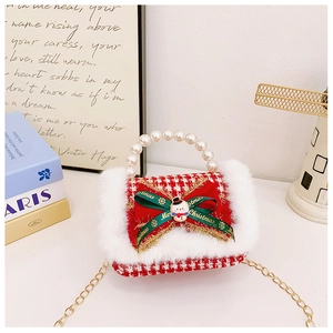 Macro detail of red plaid girls bag with white faux fur trim and pearl handle