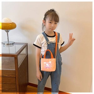 Detail of cute pink cartoon bear print and orange straps on kids small canvas handbag