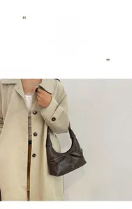 Detailed view of the dark brown vintage shoulder bag with trench coat lapel design