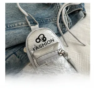 Close-up of silver metallic mini pouch with earphone icon and fashion lettering