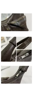 Detail of premium brown leather and plaid fabric texture with precise silver zipper