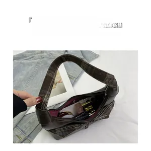 Internal view showing storage capacity for cosmetics in this stylish textured shoulder bag