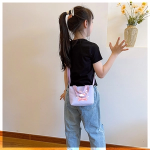 Detail view of purple canvas toddler bag featuring cartoon rabbit print and long strap