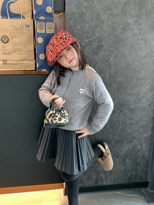 Tenue de fille avec mini sac à main léopard, cardigan en maille et béret à carreaux rouge