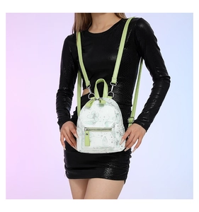 Nahaufnahme eines Mini-Rucksacks mit Blumenmuster, grünen Trägern und Schmetterlingen