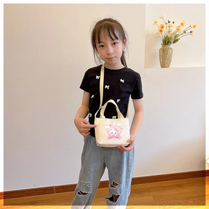 Close-up of kids canvas handbag with cute cartoon bear print and pink heart detail