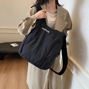 Minimalist black nylon crossbody tote bag with FASHION lettering for urban leisure style