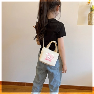 Detail of cute bear print and heart pattern on cream canvas shoulder bag for kids