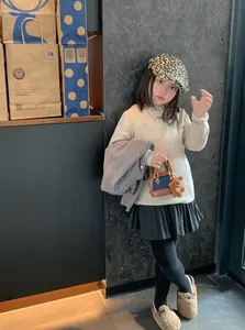 Fashionable leopard print beret with a stylish denim shell bag and warm winter clothes