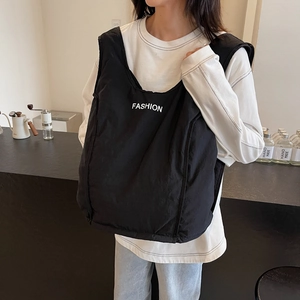 Quilted black puffer tote bag with Fashion lettering shown in a casual lifestyle setting