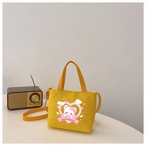 Detailed view of yellow toddler canvas bag featuring cute bear print and heart pattern