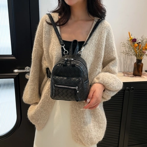 Chic black woven texture mini backpack with silver zippers and thin leather straps
