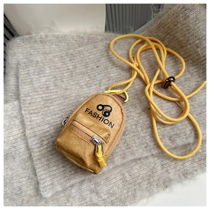 Detailed shot of yellow mustard mini pouch with pebbled texture and fashion logo