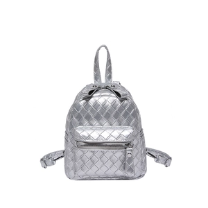 Silver mini backpack for women featuring woven faux leather texture and a metallic finish