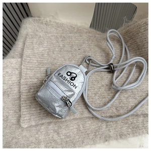 Close-up of silver mini backpack coin purse with Fashion text and adjustable neck strap
