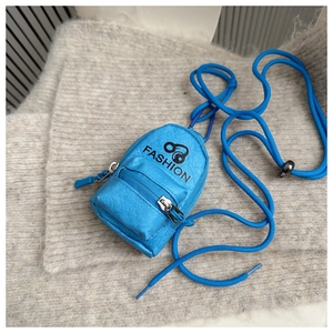 Detail showing the lychee grain texture and zipper of the blue mini headphone pouch