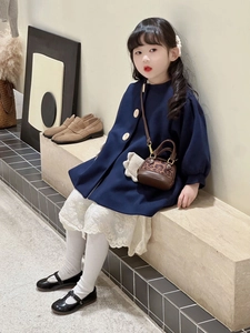 Girl's navy coat paired with leopard print mini crossbody shell bag on a young child model