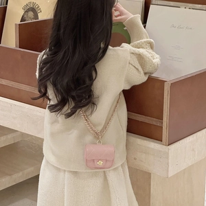 Pink quilted chain crossbody bag for children with a gold floral charm and shiny finish