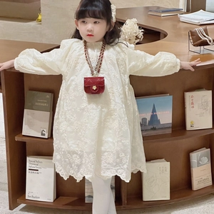 Girl in white lace dress with a stylish red quilted chain crossbody mini bag