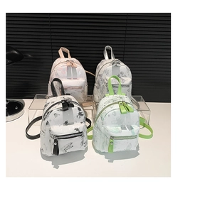 Nahaufnahme kleiner Blumenrucksäcke in den Farben Rosa, Silber, Schwarz und Grün