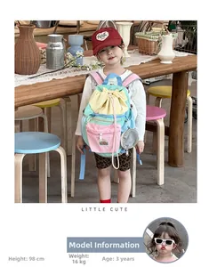 Detail of colorful drawstring kids backpack with macaron panels and round pouch charm