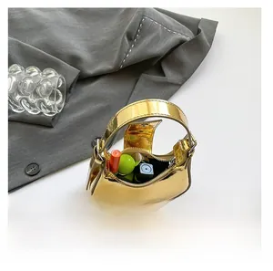 Interior view showing capacity for lipstick and cosmetics in a gold mini handbag