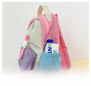 Detail view of the side elastic pocket and multi-color patchwork design on the kids backpack