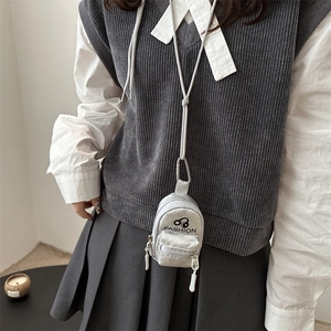 Chic silver mini neck pouch with black FASHION text and dual zipper pockets on a model