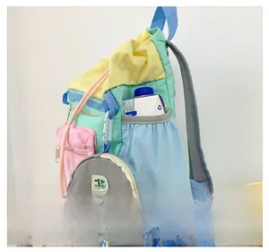 Detail of colorful kids backpack side pocket with drawstring and small charm bag