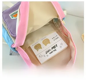 Detailed interior of color-block backpack showing spacious compartments and nylon texture