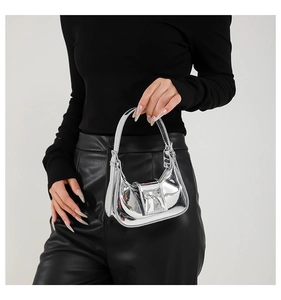 Close-up of metallic silver mirror finish handbag featuring a glossy bow detail