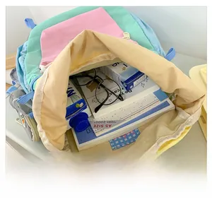 Detail view of large interior capacity showing A5 books and accessories in colorful backpack