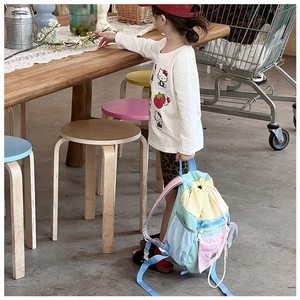 Detailed view of kids colorful patchwork drawstring backpack with pastel nylon fabric