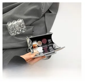 Macro view of silver mirror bag interior showing capacity for lipsticks and chain strap