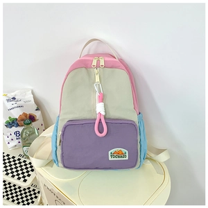 Detail of multi-color kids backpack with durable nylon fabric and branded mountain patch