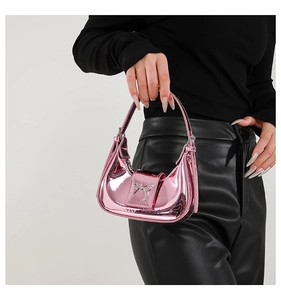 Close-up of pink metallic crescent handbag featuring a silver bow buckle decoration
