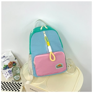 Detail of multi-color waterproof nylon kids backpack with sturdy zippers and side pockets