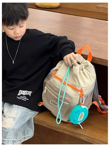Kids outdoor drawstring backpack in beige and orange with a round matching coin purse