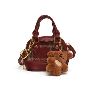 Mini burgundy shell bag with checkered tweed and a brown teddy bear plush accessory