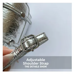 Macro detail of adjustable silver leather shoulder strap with metallic buckle