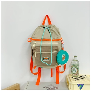 Detail of outdoor kids backpack with orange straps and a mini round side pouch