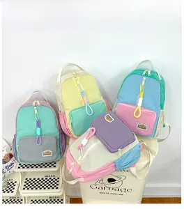 Detail showing macaron-colored patchwork nylon backpacks with a focus on straps and brand logo