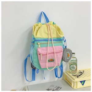 Detail of colorful drawstring backpack with front zipper pocket and matching round coin purse